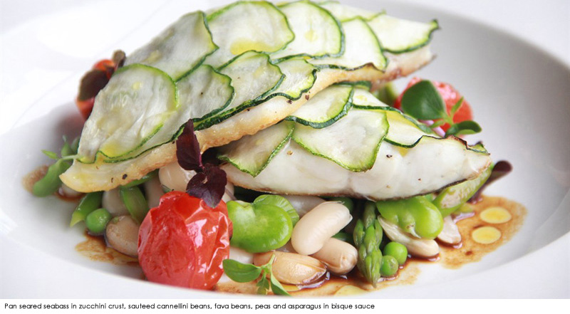 Pan seared seabass in zucchini crust, sauteed cannellini beans, fava beans, peas and asparagus in bisque sauce
